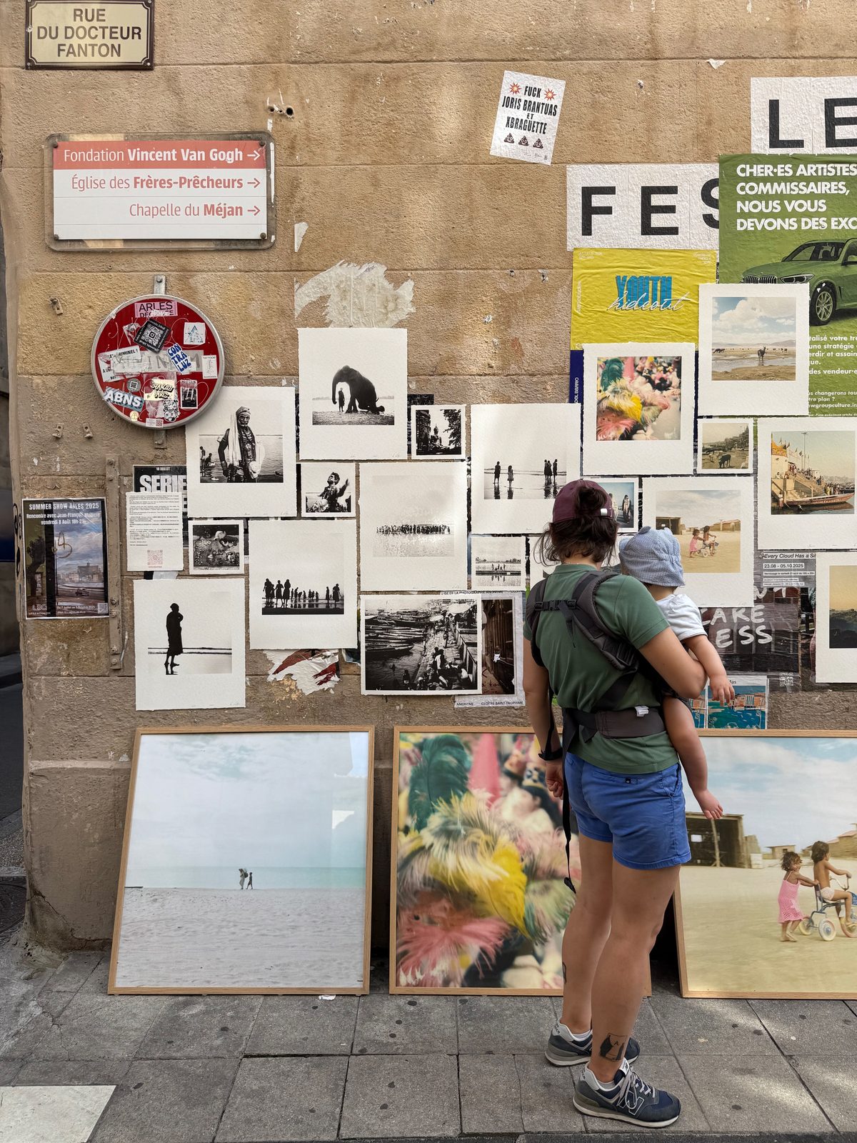 A poster- and print-covered stone wall in Arles